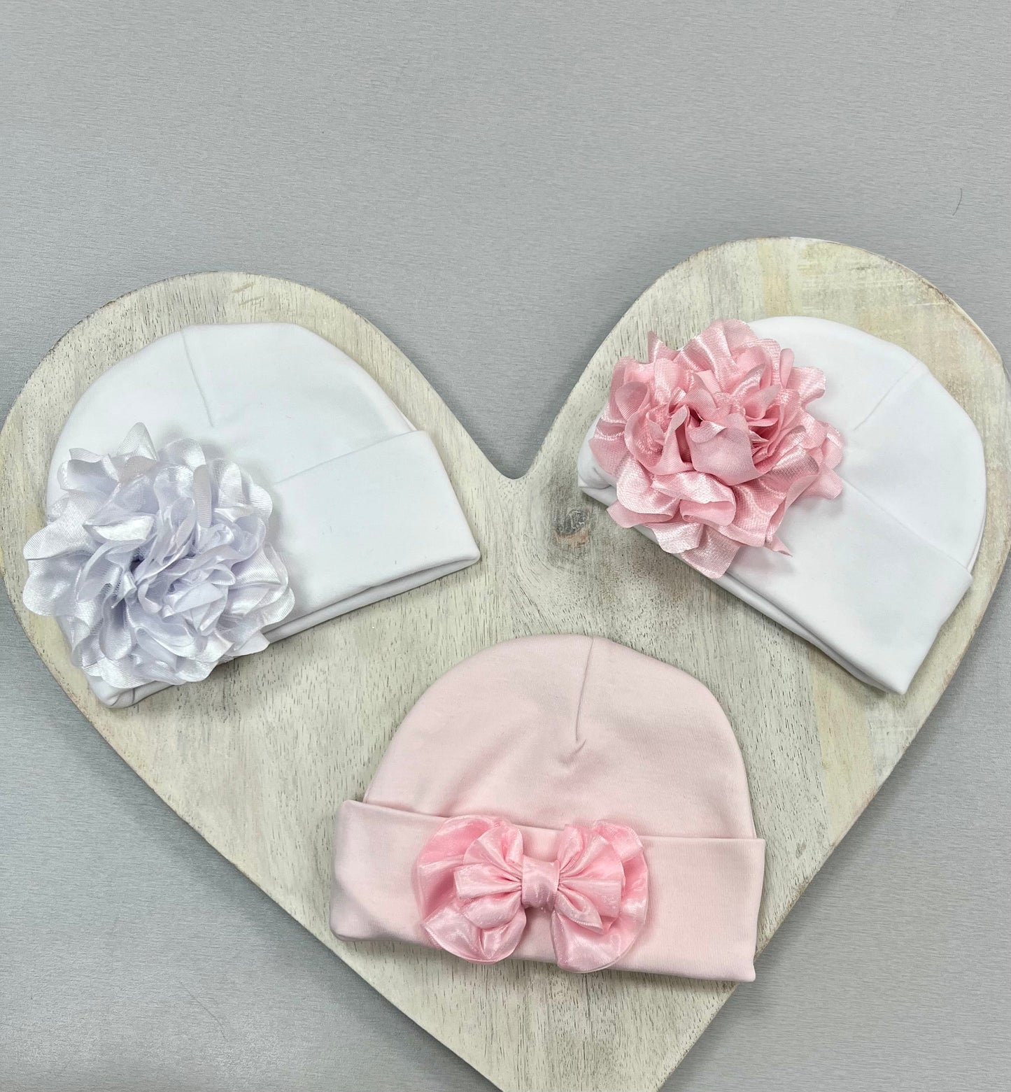 Pink and white Baby Hats with floral or bow accents