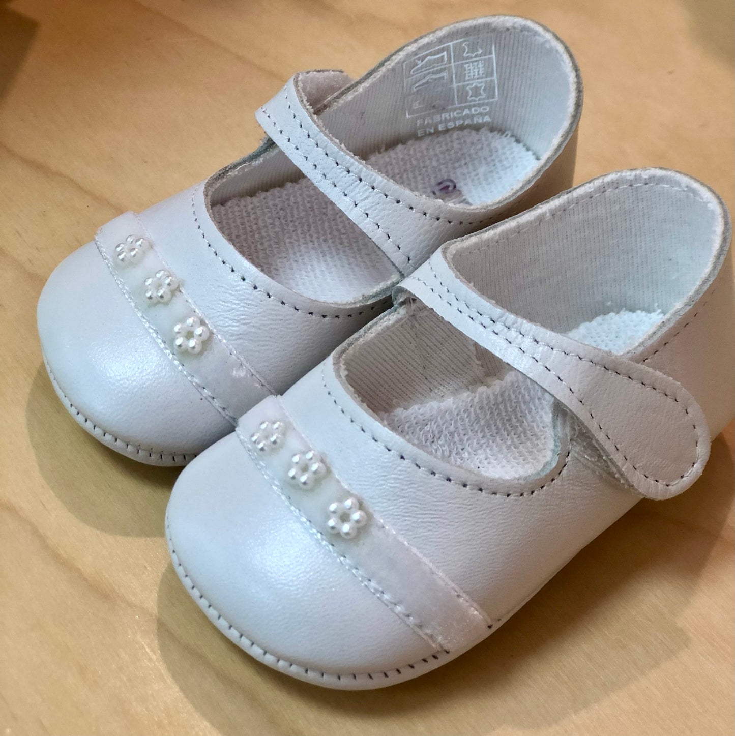 White leather baby girls soft shoes with pearl embellishments
