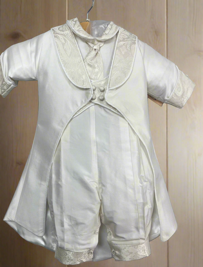 A white silk christening outfit for a baby boy, featuring a lace collar and buttons down the front, displayed on a wooden hanger.