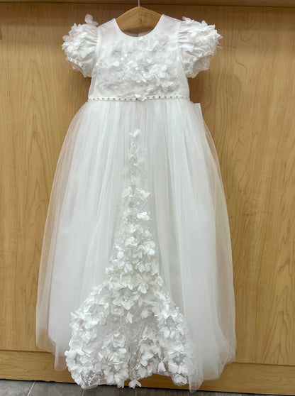An off white christening dress with 3D floral details and cap sleeves