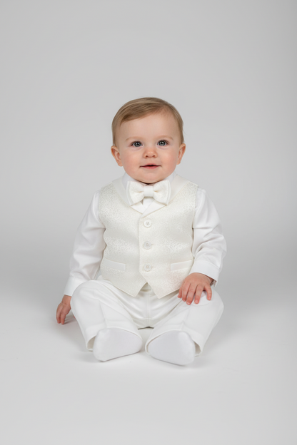 Baby wearing a white suit with a bow tie on a light gray background