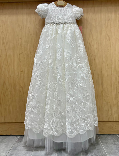 Charlie White lace Christening dress on a wooden background