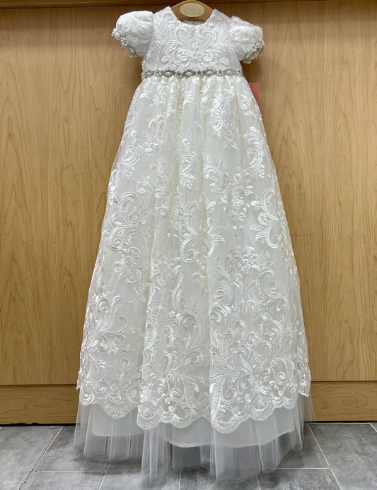 Charlie White lace Christening dress on a wooden background