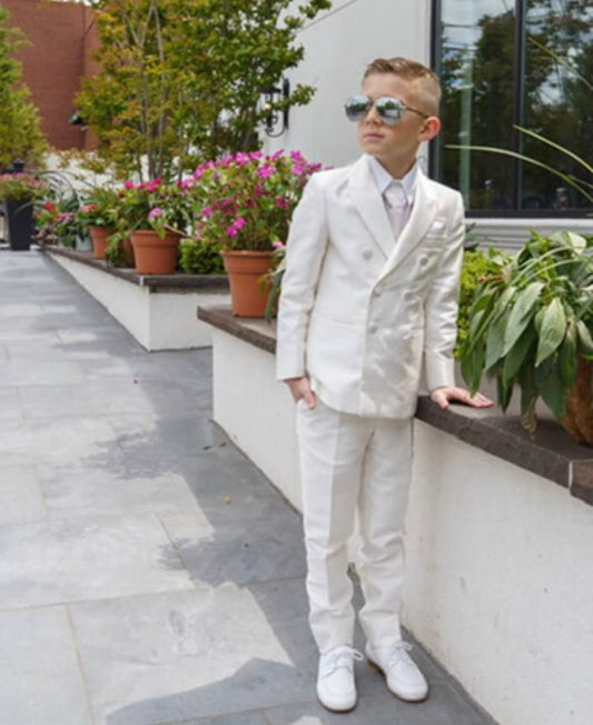 Kid wearing a white communion suit 