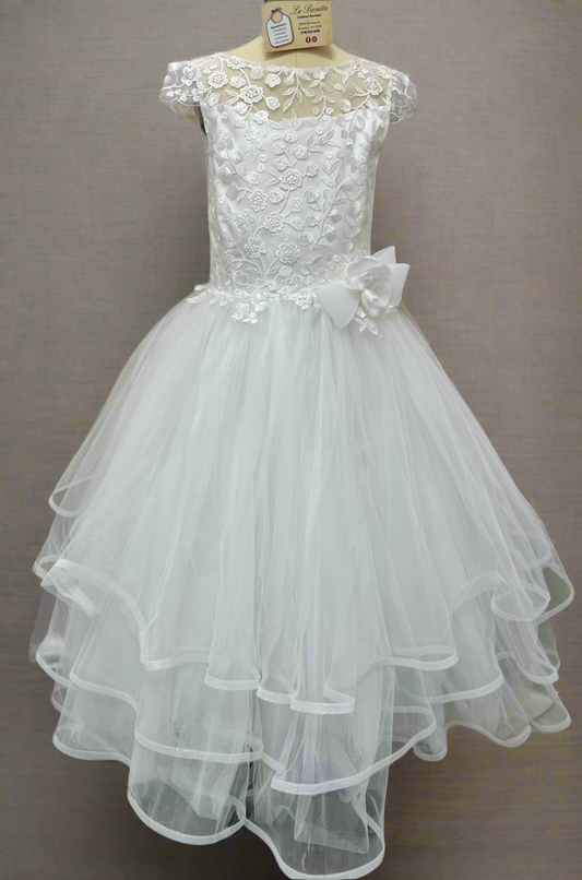 A white, tiered communion dress with cap sleeves and floral embroidery, displayed on a mannequin against a plain background.