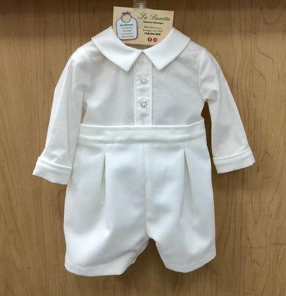 White baby Christening romper with collar on a wooden background