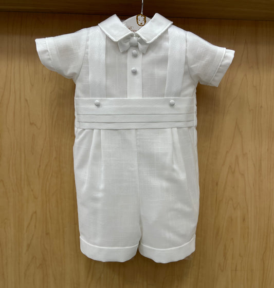 White cotton boys' baptism suit with textured suspenders, cummerbund, and matching cap, displayed on a wooden hanger.