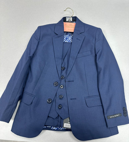 A blue boys' communion suit consisting of a single-breasted, two-button jacket, slim-fit pants, and a vest. The suit is displayed on a hanger.
