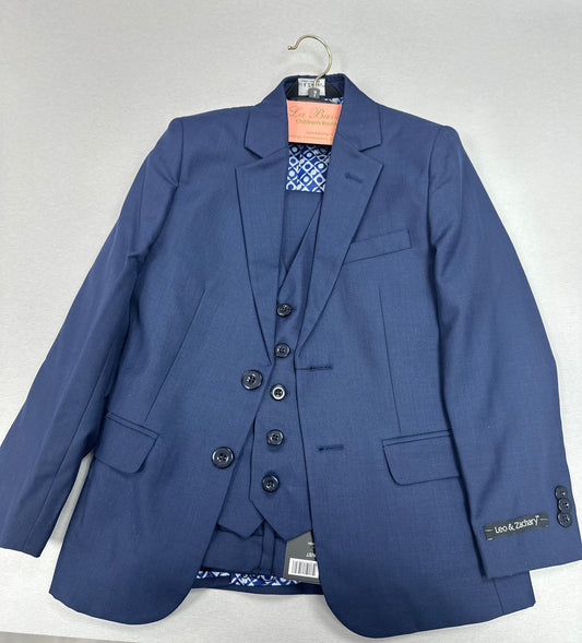 A blue boys' communion suit consisting of a single-breasted, two-button jacket, slim-fit pants, and a vest. The suit is displayed on a hanger.