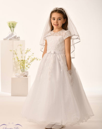 Young girl in a white lace communion  dress with a veil on a white background. By la Bavetta in Brooklyn